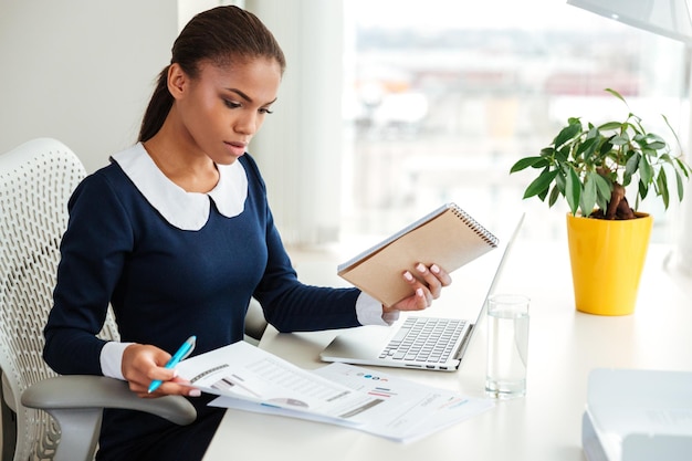 A carefully ordered desk — case files, a notepad, quiet focus